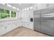 Bright kitchen features white cabinets, hardwood floors, and stainless steel appliances at 2400 Worth Ave, Loganville, GA 30052