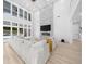 Bright living room with shiplap wall, fireplace, and floor-to-ceiling windows at 2400 Worth Ave, Loganville, GA 30052