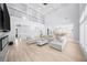 Spacious living room with floor-to-ceiling windows, modern decor, and fireplace at 2400 Worth Ave, Loganville, GA 30052