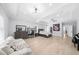 Expansive main bedroom featuring tray ceilings, hardwood floors, and a sitting area with ample natural light at 2400 Worth Ave, Loganville, GA 30052