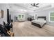 Spacious main bedroom featuring hardwood floors, a ceiling fan, and large windows providing natural light at 2400 Worth Ave, Loganville, GA 30052