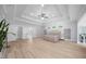 Spacious main bedroom featuring hardwood floors, tray ceilings, windows, and access to the ensuite bathroom at 2400 Worth Ave, Loganville, GA 30052