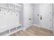 Modern mudroom with built-in storage, coat hooks, and access to the garage at 2400 Worth Ave, Loganville, GA 30052