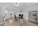 Bright home office with glass desk, wall art and hardwood flooring at 2400 Worth Ave, Loganville, GA 30052