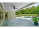 Covered patio with outdoor fan overlooking the pool and backyard at 2400 Worth Ave, Loganville, GA 30052