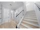 Modern staircase featuring light wood treads, glass railings and white risers at 2400 Worth Ave, Loganville, GA 30052
