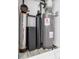 Utility room showing a water heater and filtration system in the basement of the home at 2400 Worth Ave, Loganville, GA 30052