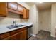Traditional kitchen with wooden cabinetry, stainless steel dishwasher and neutral countertops at 2986 Parc Lorraine, Lithonia, GA 30038