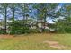 A view of the home's backyard, showing the treeline and exterior siding at 331 Overlook Turn Nw, Conyers, GA 30012