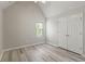 Bedroom features vaulted ceilings, gray wood floors, double door closet, and natural light at 331 Overlook Turn Nw, Conyers, GA 30012