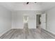 Bedroom with gray wood flooring, tray ceilings, and access to en-suite bathroom at 331 Overlook Turn Nw, Conyers, GA 30012