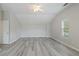 Bedroom with vaulted ceilings, gray wood floors, and natural light from the window at 331 Overlook Turn Nw, Conyers, GA 30012