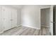 Bedroom boasts double door closet, neutral walls, gray wood floors and access to hallway at 331 Overlook Turn Nw, Conyers, GA 30012