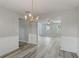 Dining room with a view into the living room and featuring hardwood floors and wainscoting at 331 Overlook Turn Nw, Conyers, GA 30012