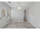 Bright dining room features gray wood floors, white walls, and modern dome pendant lighting at 331 Overlook Turn Nw, Conyers, GA 30012