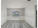 Bright dining room features hardwood floors, wainscoting, and a chandelier at 331 Overlook Turn Nw, Conyers, GA 30012