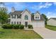 Charming two-story home featuring an attached two-car garage and manicured front lawn at 331 Overlook Turn Nw, Conyers, GA 30012
