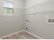 Laundry area with window view, wire shelving and gray wood flooring at 331 Overlook Turn Nw, Conyers, GA 30012