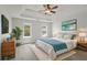 Bright main bedroom features tray ceilings, a ceiling fan, and two windows for natural light at 331 Overlook Turn Nw, Conyers, GA 30012