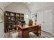 Home office featuring a vaulted ceiling, hard wood floors, a large desk, and built-in bookcase at 331 Overlook Turn Nw, Conyers, GA 30012