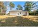 Rear view of the house highlighting the backyard, with a grassy area and access door at 389 Campground School Rd, Dallas, GA 30157