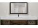 Bathroom vanity featuring modern white countertop, dark brown cabinets, and a large, framed mirror at 389 Campground School Rd, Dallas, GA 30157
