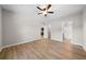 Bright bedroom features light wood floors, a ceiling fan, and ensuite bath with a glass-enclosed shower at 389 Campground School Rd, Dallas, GA 30157