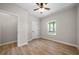 Bedroom featuring wood-look floors, white door, and a window allowing natural light at 389 Campground School Rd, Dallas, GA 30157