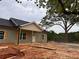 New home under construction with a covered porch and wooden detailing on the facade at 389 Campground School Rd, Dallas, GA 30157