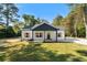 Charming one-story home boasts a well-manicured lawn, complemented by tasteful wooden shutters and a modern black accent wall at 389 Campground School Rd, Dallas, GA 30157
