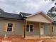 New construction home featuring wood shutters, covered porch, and fresh exterior paint at 389 Campground School Rd, Dallas, GA 30157