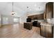 This eat-in kitchen has an island, wooden cabinets, pendant lighting, and stainless appliances, opening to the dining room at 389 Campground School Rd, Dallas, GA 30157