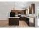 This updated kitchen has wooden cabinets, granite countertops, stainless appliances, an island, and wood flooring at 389 Campground School Rd, Dallas, GA 30157
