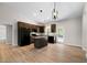 Modern eat-in kitchen features an island, granite countertops, wood cabinets, pendant lighting, and black appliances at 389 Campground School Rd, Dallas, GA 30157