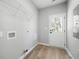 Functional laundry room features wood-style flooring, overhead shelving, and a convenient exterior access door at 389 Campground School Rd, Dallas, GA 30157