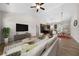 This open floor plan offers a large living room, a view of the dining room, and a kitchen with wooden cabinets and island at 389 Campground School Rd, Dallas, GA 30157