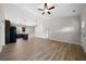 Open-concept living space with vaulted ceiling, wood flooring, pendant lights, and seamlessly connected modern kitchen at 389 Campground School Rd, Dallas, GA 30157