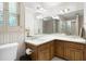 Bathroom features double sink vanity, a toilet, and a large mirror at 2101 Breconridge Sw Dr, Marietta, GA 30064