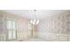 Traditional dining room with floral wallpaper, chair railing, and a chandelier at 2101 Breconridge Sw Dr, Marietta, GA 30064
