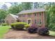 Charming brick home with lush landscaping including bushes and vibrant plants at 2101 Breconridge Sw Dr, Marietta, GA 30064