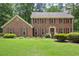 Beautiful two-story brick home featuring a well-manicured lawn and mature landscaping at 2101 Breconridge Sw Dr, Marietta, GA 30064