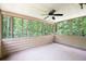 Relaxing screened porch with ceiling fan and wooded views through multiple large windows at 2101 Breconridge Sw Dr, Marietta, GA 30064