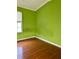 Bedroom featuring hardwood floors, a window and bright green walls at 2653 Parkway Trl, Lithonia, GA 30058