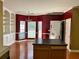 Kitchen featuring wood floors, chandelier, island, and bright red walls at 2653 Parkway Trl, Lithonia, GA 30058