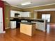 Open kitchen with island, updated white cabinets, and hardwood flooring at 2653 Parkway Trl, Lithonia, GA 30058