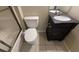 Bathroom with black vanity, toilet, tile floors, and shower at 345 Deerwood Dr, Suwanee, GA 30024