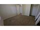 Bedroom with carpeted floors, closet, and entry door at 345 Deerwood Dr, Suwanee, GA 30024