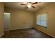 Simple bedroom with ceiling fan, window, carpet, and an ensuite bathroom through the doorway at 345 Deerwood Dr, Suwanee, GA 30024
