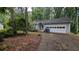 Charming home with a two-car garage and front yard ready for landscaping at 345 Deerwood Dr, Suwanee, GA 30024