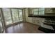 Eat-in kitchen featuring a window overlooking the backyard, appliances and tile countertops at 345 Deerwood Dr, Suwanee, GA 30024